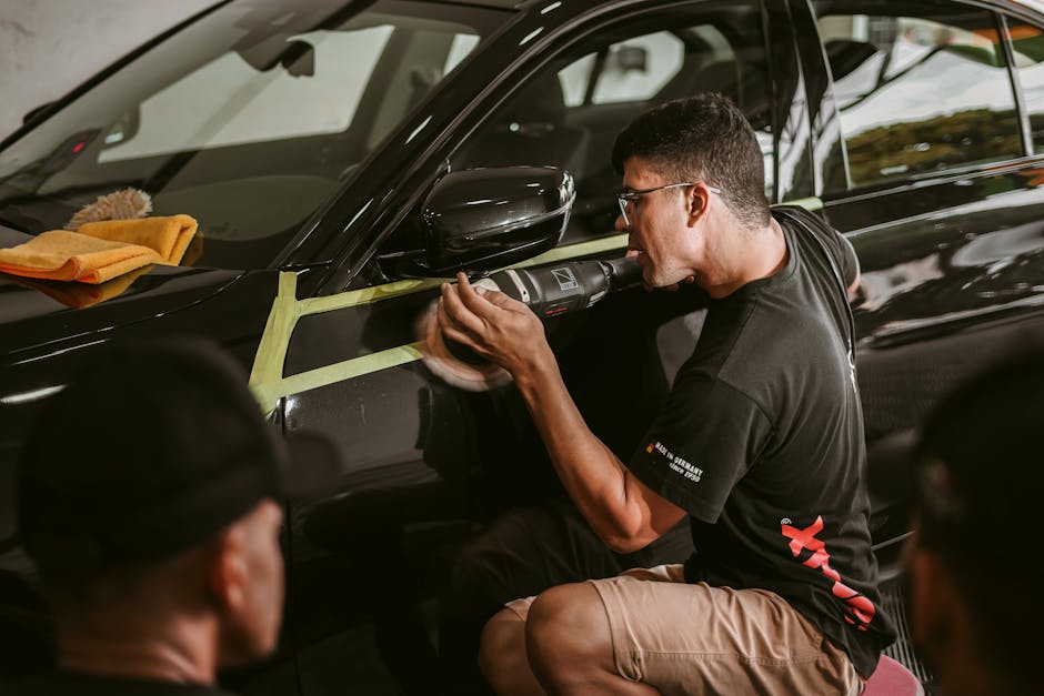 Professional auto detailing specialist polishing a vehicle